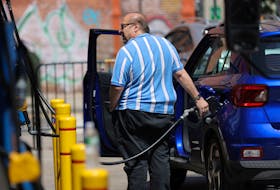 A person puts gas in a vehicle at a gas station in Manhattan, New York City, U.S., August 11, 2022.
