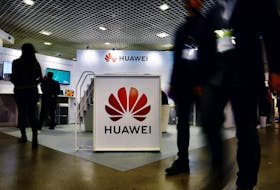 Visitors walk past the Huawei logo at the World Artificial Intelligence Cannes Festival (WAICF) in Cannes, France, February 10, 2023.