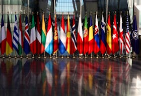 National flags hang at the entrance, ahead of the NATO foreign ministers meeting, at the Alliance's headquarters in Brussels, Belgium November 28, 2023.