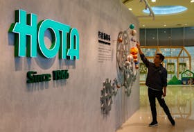 Morris Wu, Director of Sales and Marketing of Hota Industrial demonstrates a model of gears featuring planets of the Solar system by the company logo, in Taichung, Taiwan November 13, 2023.