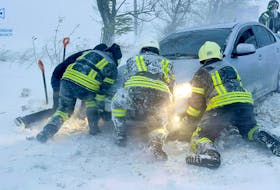 Emergency workers release a car which stuck in snow during a heavy snow storm in Odesa region, Ukraine in this handout picture released November 27, 2023. Press service of the State Emergency Service of Ukraine in Odesa region/Handout via