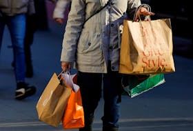 A woman carries shopping bags during the holiday season in New York City, U.S., December 21, 2022.