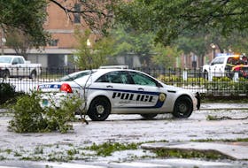 A Mobile Police Department vehicle drives down Government Street during Hurricane Sally in Mobile, Alabama, U.S., September 16, 2020. 