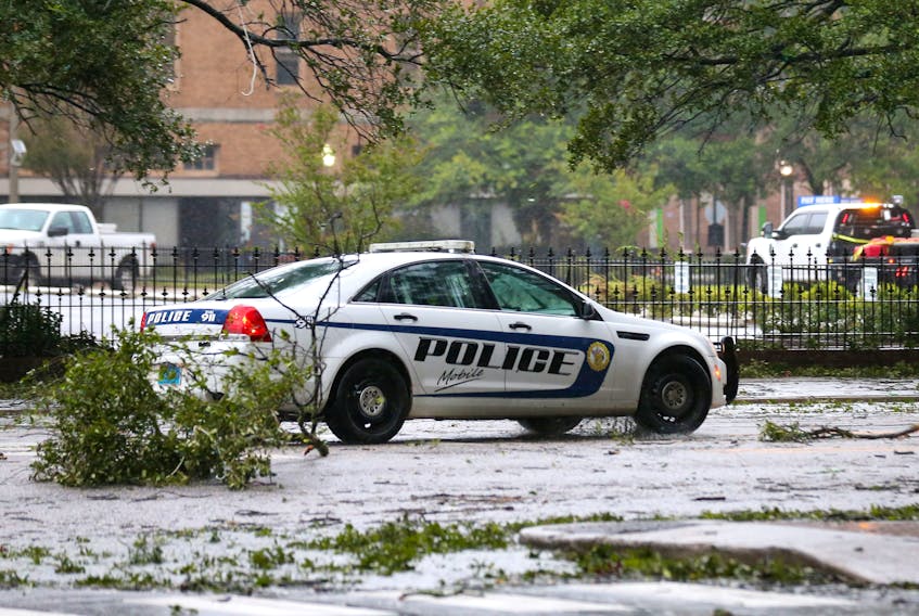 A Mobile Police Department vehicle drives down Government Street during Hurricane Sally in Mobile, Alabama, U.S., September 16, 2020. 