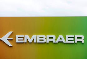 Signage for Embraer is seen on a trade pavilion at the Farnborough International Airshow, in Farnborough, Britain, July 20, 2022. 