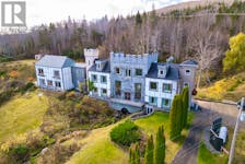 This aerial view shows off the castle-like features and some of the 163 acres of property. - realtor.ca
