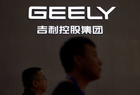 People walk past a Geely sign at its booth during the first China International Supply Chain Expo (CISCE) in Beijing, China November 28, 2023.