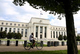 A cyclist passes the Federal Reserve building in Washington, DC, U.S., August 22, 2018.