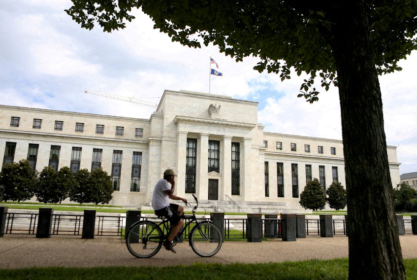 A cyclist passes the Federal Reserve building in Washington, DC, U.S., August 22, 2018.