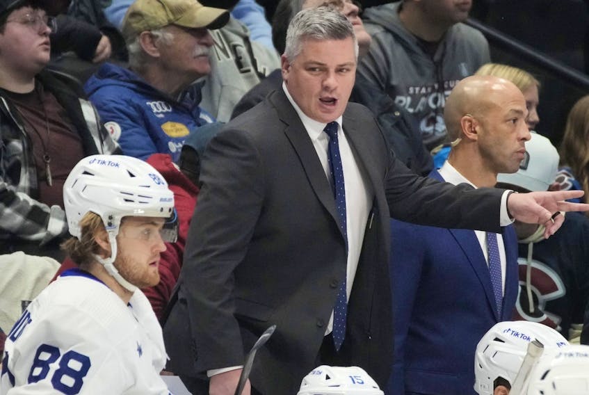 Toronto Maple Leafs coach Sheldon Keefe talks to his player during a game against the Colorado Avalanche. 