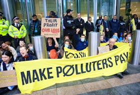 Demonstrators attend an 'Oily Money Out' protest against fossil fuel companies outside Barclays Bank, in London, Britain, October 19, 2023.