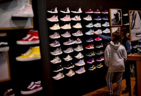 Audrey Topkin, 11, selects sneakers with her mother, Robyn, at a Dick's Sporting Goods store as pre-Thanksgiving and Christmas holiday shopping accelerates at the King of Prussia Mall in King of Prussia, Pennsylvania, U.S. November 22, 2019.