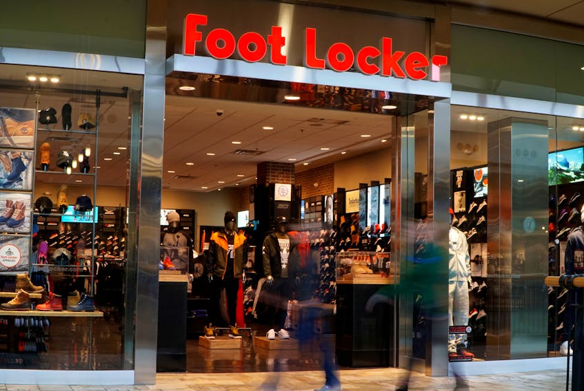 Customers walk by the Foot Locker store in Broomfield, Colorado in a slow shutter exposure November 17, 2016. 