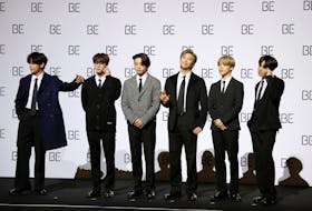 Members of K-pop boy band BTS pose for photographs during a news conference promoting their new album "BE(Deluxe Edition)" in Seoul, South Korea, November 20, 2020.