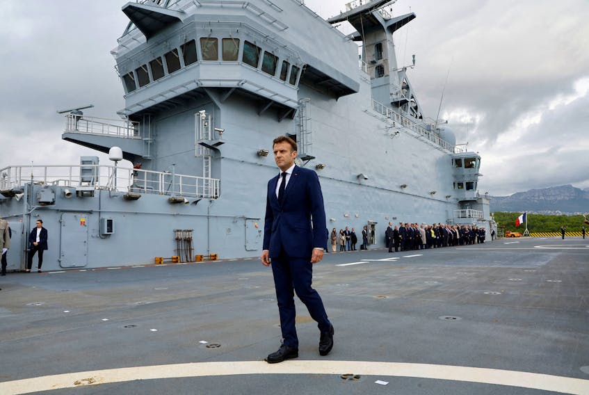 French President Emmanuel Macron walks on the deck of the amphibious helicopter carrier Dixmude docked in the French Navy base of Toulon, France, November 9, 2022.