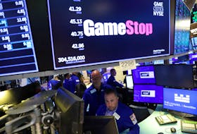 Traders work under signage for GameStop Corp. (NYSE: GME) on the trading floor at the New York Stock Exchange (NYSE) in Manhattan, New York City, U.S., August 8, 2022.