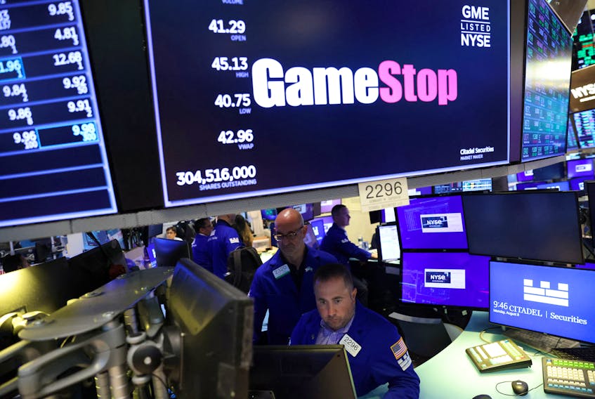 Traders work under signage for GameStop Corp. (NYSE: GME) on the trading floor at the New York Stock Exchange (NYSE) in Manhattan, New York City, U.S., August 8, 2022.