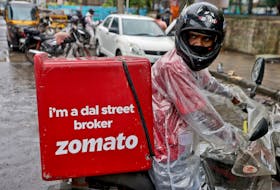 A delivery worker of Zomato, an Indian food-delivery startup, prepares to leave to pick up an order from a restaurant in Mumbai, India, July 13, 2021.