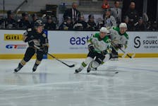 Charlottetown Islanders forward Giovanni Morneau, 8, passes the puck while under pressure from the Val-d’Or Foreurs’ Philippe Veilleux, 44, and team captain David Doucet, 91. The action took place during the first period of a Quebec Major Junior Hockey League (QMJHL) game at Eastlink Centre in Charlottetown on Nov. 25. Val-d’Or won the game 3-2 in overtime. Jason Simmonds • The Guardian