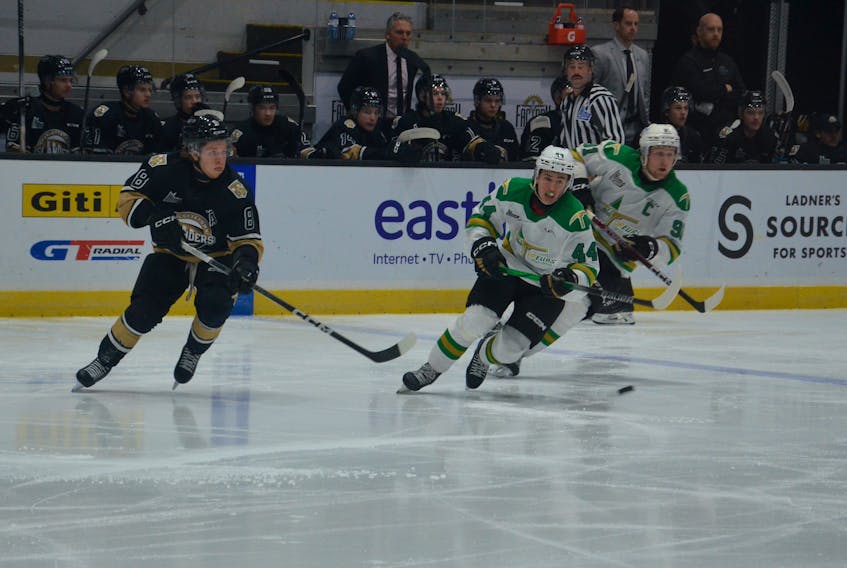 Charlottetown Islanders forward Giovanni Morneau, 8, passes the puck while under pressure from the Val-d’Or Foreurs’ Philippe Veilleux, 44, and team captain David Doucet, 91. The action took place during the first period of a Quebec Major Junior Hockey League (QMJHL) game at Eastlink Centre in Charlottetown on Nov. 25. Val-d’Or won the game 3-2 in overtime. Jason Simmonds • The Guardian