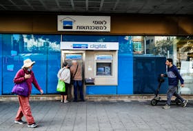 People use an ATM at a branch of Bank Leumi in Tel Aviv, Israel November 22, 2021. Picture taken November 22, 2021.