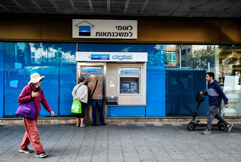 People use an ATM at a branch of Bank Leumi in Tel Aviv, Israel November 22, 2021. Picture taken November 22, 2021.