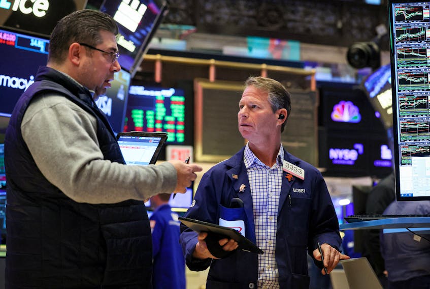 Traders work on the trading floor at the New York Stock Exchange (NYSE) in New York City, U.S., November 22, 2023. 