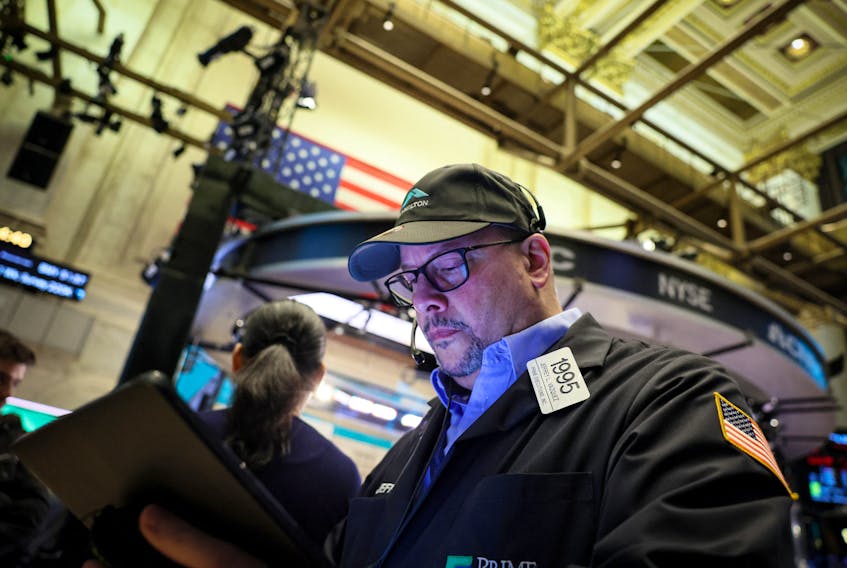 Traders work on the floor at the New York Stock Exchange (NYSE) in New York City, U.S., November 16, 2023. 