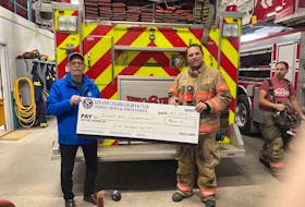 Brian Bonnar, vice president of Kiwanis Ceilidh Golden K Northside is shown presenting a cheque for $1,000 to John Chant, who is the chief of the Glace Bay Fire Department.