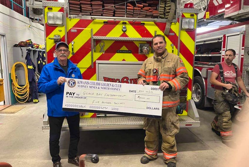 Brian Bonnar, vice president of Kiwanis Ceilidh Golden K Northside is shown presenting a cheque for $1,000 to John Chant, who is the chief of the Glace Bay Fire Department.