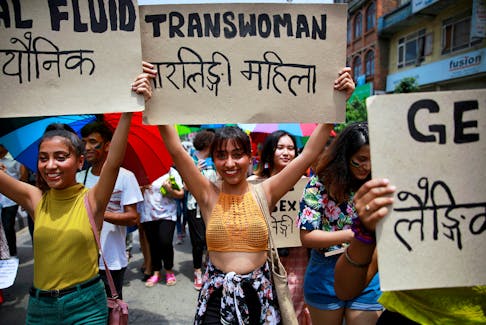 Participants hold up placards while taking part in a Gay Pride parade to mark pride month in Kathmandu, Nepal, June 29, 2019.
