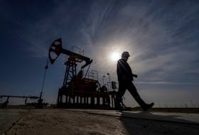 An oil and gas industry worker walks during operations of a drilling rig at Zhetybay field in the Mangystau region, Kazakhstan, November 13, 2023.