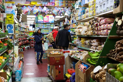 People shop at a grocery market, in London, Britain May 6, 2023.