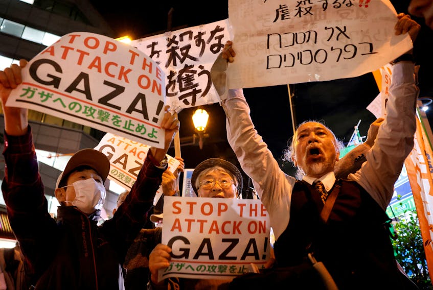People hold a rally to protest against Israel's attack on Gaza near the Israeli embassy in Tokyo, Japan October 16, 2023. 