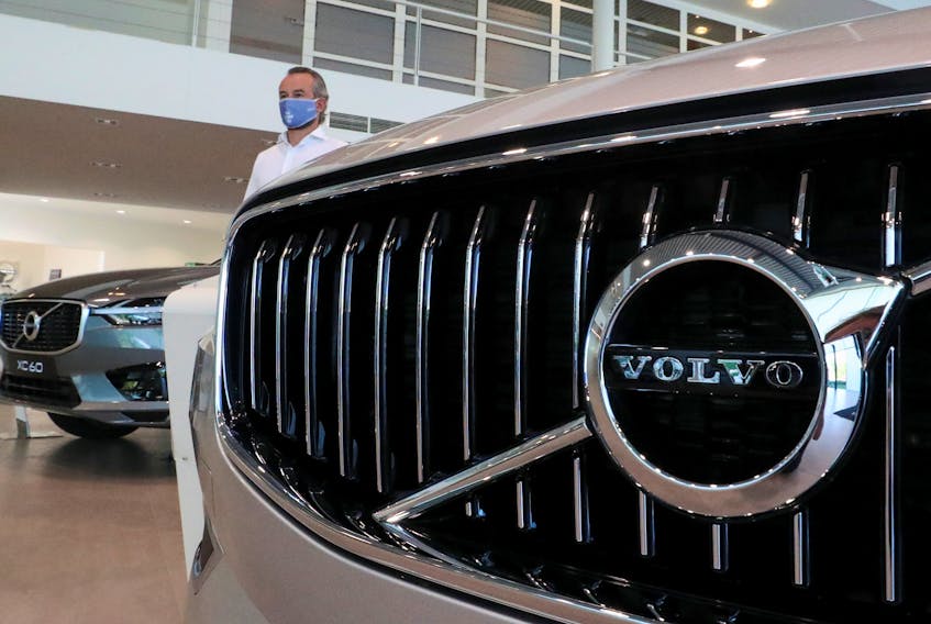 An employee at a Volvo car dealer, wearing a protective mask is seen in the showroom, amid the coronavirus disease (COVID-19) outbreak in Brussels, Belgium May 28, 2020.
