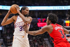 Kevin Durant #35 of the Phoenix Suns battles against OG Anunoby of the Toronto Raptors during first half action at the Scotiabank Arena on November 29, 2023 in Toronto.