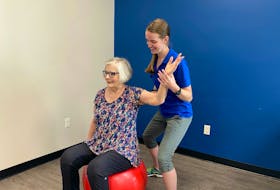 Zoomers physiotherapist Maggie Sullivan helps Joan Putnam work on her shoulder mobility and core strength. CONTRIBUTED