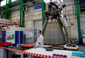 A worker of Ariane Group stands in front of a Ariane 6 rocket's Vulcain 2.1 engine, prior to the visit of French President Emmanuel Macron, in Vernon, France January 12, 2021. Christophe Ena/Pool via