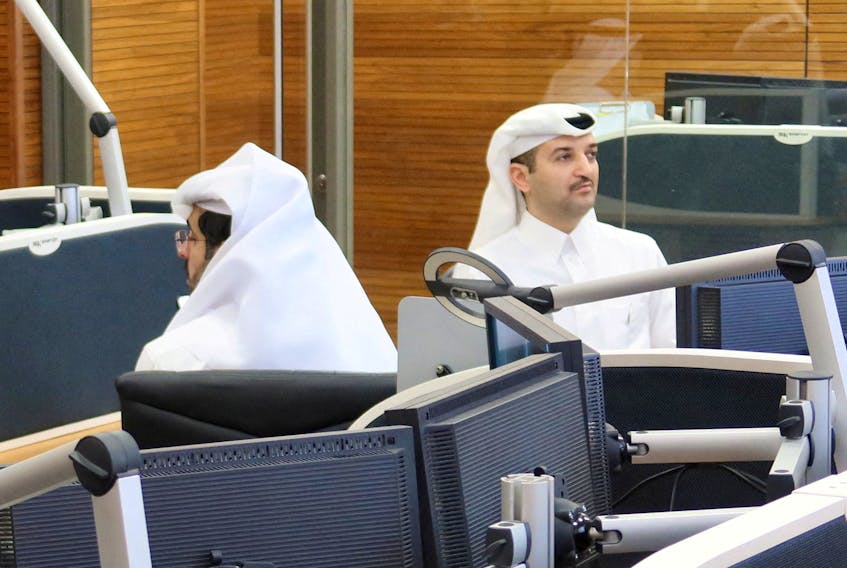 One of Qatar’s lead negotiators Abdullah Al Sulaiti (R) works inside an operation room set up to coordinate the truce and release of hostages between Israel and the Palestinian Islamist group Hamas, at the National Command Centre in Doha, Qatar November 26, 2023.  