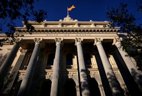 A Spanish flag flutters above the Madrid Stock Exchange, Spain, June 1, 2016.