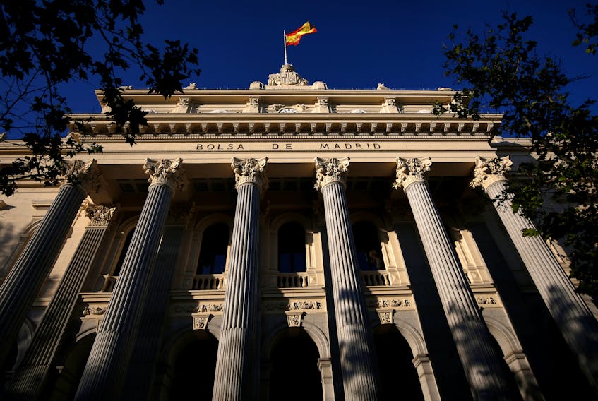 A Spanish flag flutters above the Madrid Stock Exchange, Spain, June 1, 2016.