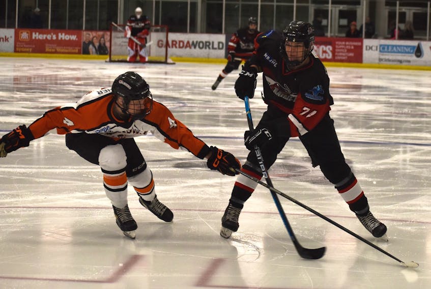 Colby McCarron of the Membertou Jr. Miners, right, prepares to fire a shot on goal as he’s pressured by Cameron Bewsher of the Sackville Blazers during Nova Scotia Junior Hockey League action at the Membertou Sport and Wellness Centre in November. The league will have a new neck guard rule in place for early January. JEREMY FRASER/CAPE BRETON POST