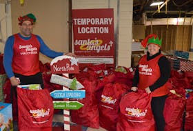 Kenny Zakem, left, and Colleen McCabe gear up for the annual Santa’s Angels charity giveaway. Santa’s Angels is in a temporary location inside Royalty Crossing but is looking for a new home. Dave Stewart • The Guardian