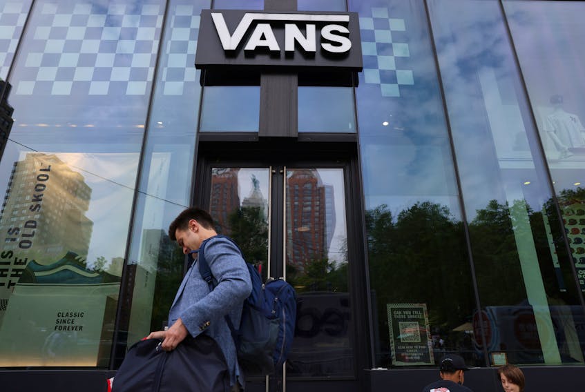 A person walks by a Vans store, a brand owned by VF Corporation, in Manhattan, New York City, U.S., May 20, 2022.