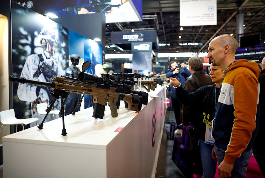 Visitors look at firearms from Colt CZ Group at the Milipol Paris, the worldwide exhibition dedicated to homeland security and safety, in Villepinte near Paris, France, November 15, 2023.