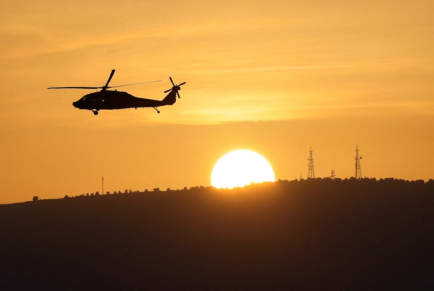 An Israeli military helicopter flies over Northern Israel near the border with Lebanon November 2, 2023.