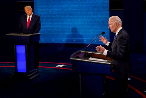 Democratic presidential candidate former Vice President Joe Biden answers a question as President Donald Trump listens during the second and final presidential debate at the Curb Event Center at Belmont University in Nashville, Tennessee, U.S., October 22, 2020. Morry Gash/Pool via REUTERS