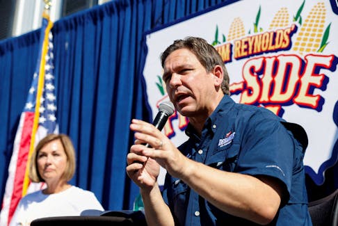 Republican presidential candidate Ron DeSantis speaks next to Iowa Governor Kim Reynolds during a "Fair-Side Chat" hosted by the governor at the Iowa State Fair in Des Moines, Iowa, U.S., August 12, 2023. 