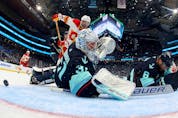 Philipp Grubauer #31 of the Seattle Kraken makes a save against Nazem Kadri #91 of the Calgary Flames during the second period at Climate Pledge Arena on November 4, 2023 in Seattle, Washington.