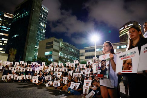 Members of the kibbutz community of Kfar Aza hold banners during a demonstration in support of the families of hostages held in Gaza, who were seized in the deadly October 7 attack by Hamas gunmen, in Tel Aviv, Israel November 2, 2023.